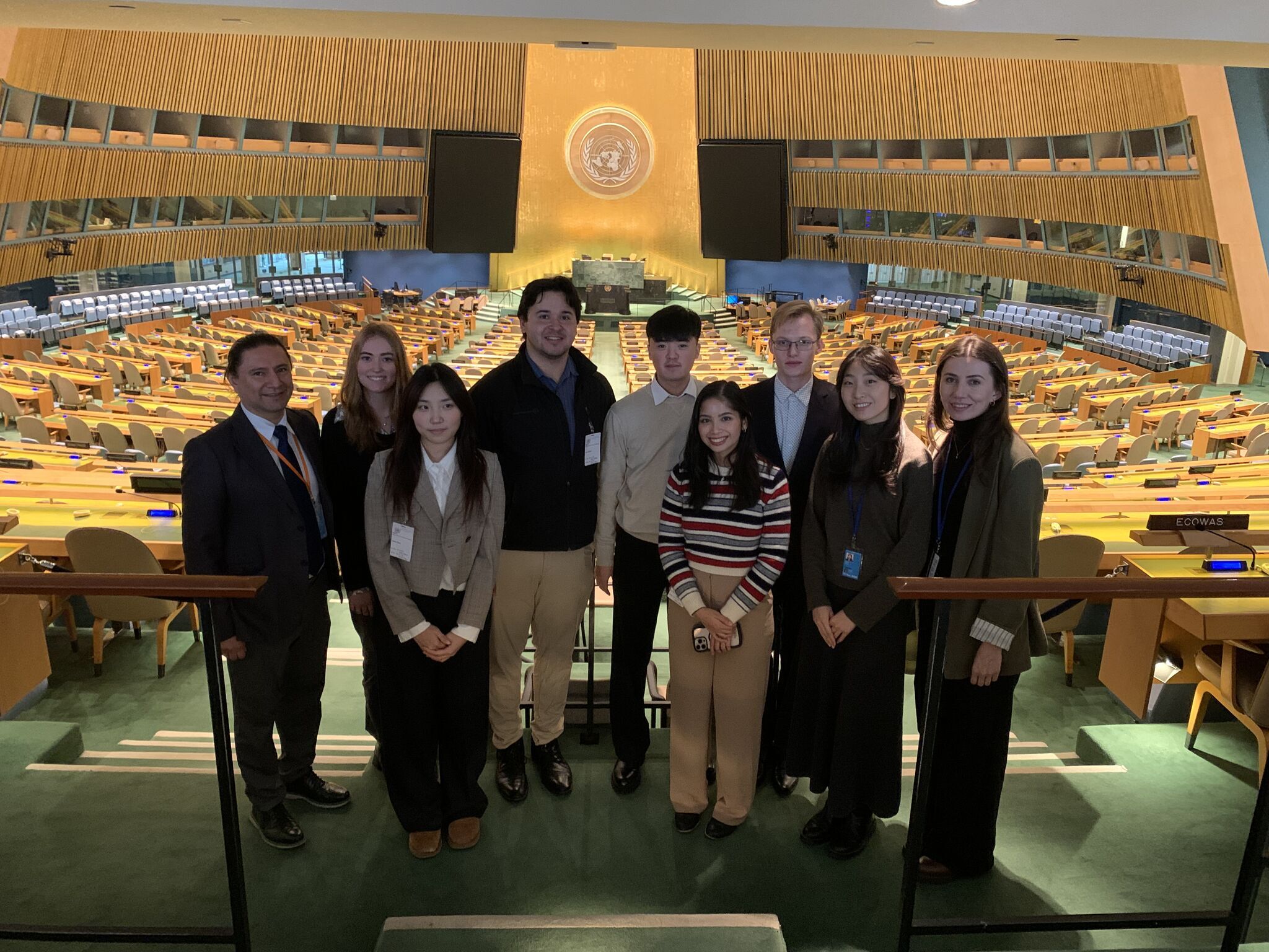 Participants of the UN Peacekeeping Innovation Sprint pose inside the General Assembly Hall at United Nations Headquarters in New York during the five-day event.