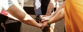 people putting their hands together