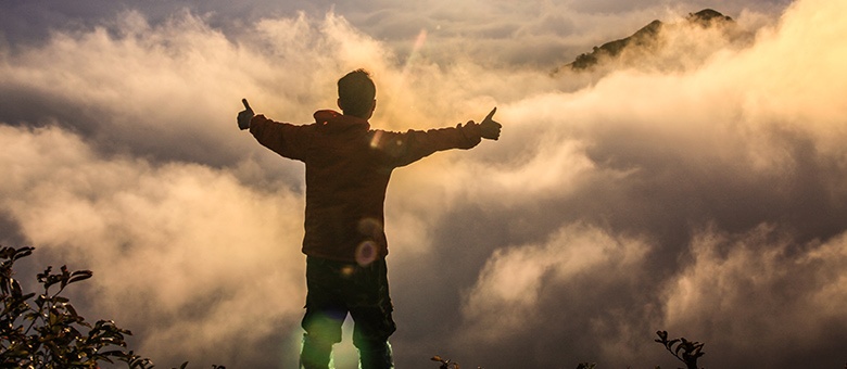 guy standing on top of a mountain
